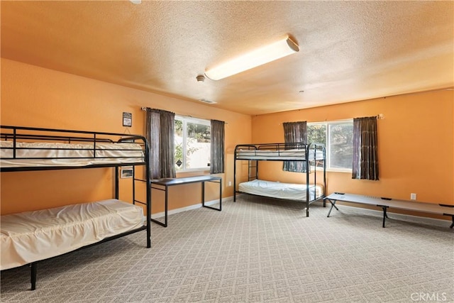 carpeted bedroom featuring a textured ceiling