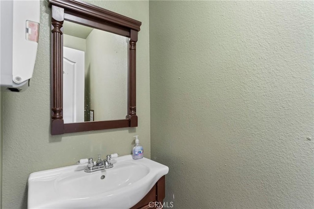 bathroom featuring water heater and sink