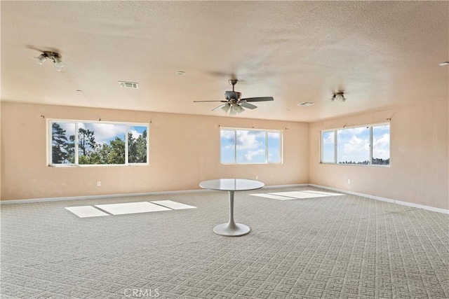 spare room with basketball hoop, ceiling fan, carpet floors, and a textured ceiling