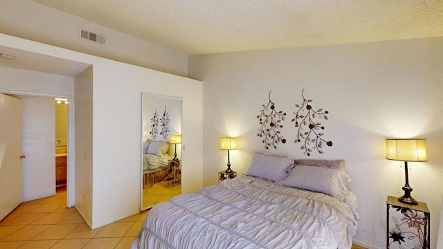 tiled bedroom featuring connected bathroom