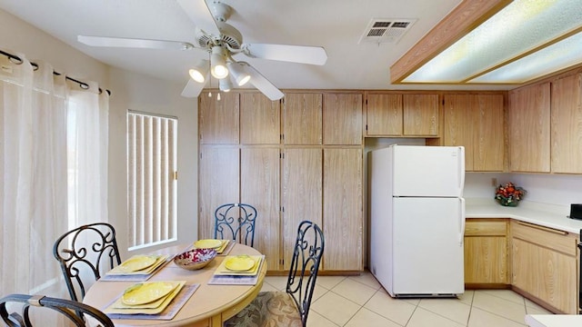 tiled dining room featuring ceiling fan