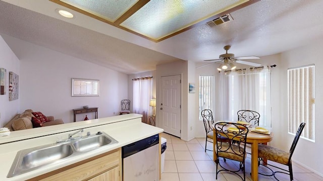 kitchen with ceiling fan, light brown cabinets, sink, stainless steel dishwasher, and light tile patterned floors