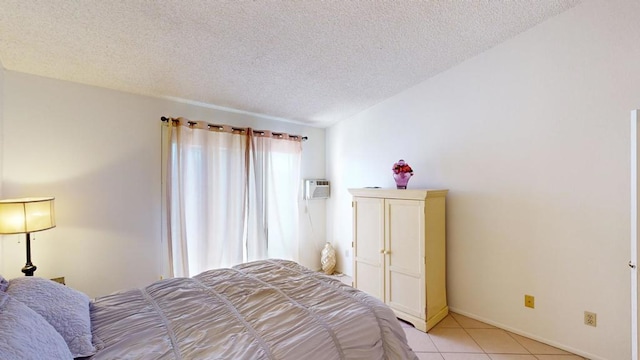 tiled bedroom featuring a textured ceiling and a wall mounted AC