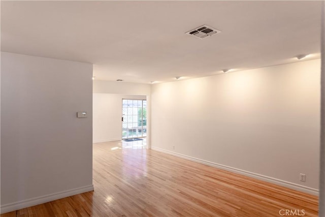 spare room featuring light hardwood / wood-style floors