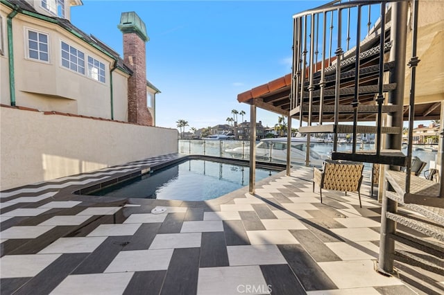 view of swimming pool with a water view