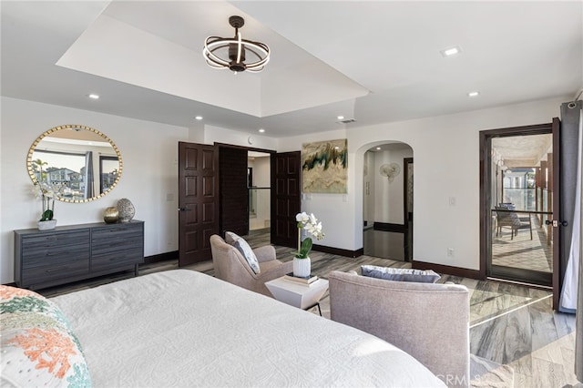 bedroom featuring access to outside and hardwood / wood-style flooring