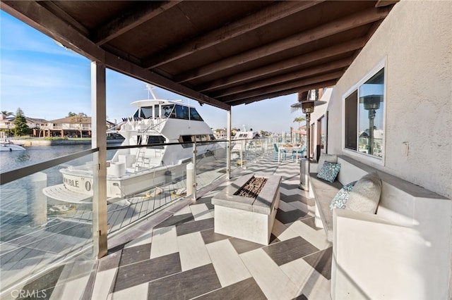 view of patio / terrace with a fire pit and a water view