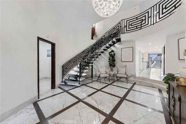 entrance foyer with a high ceiling and a notable chandelier