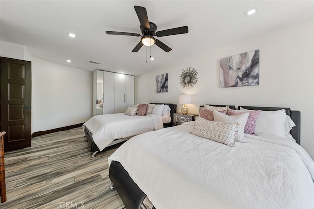 bedroom with ceiling fan and wood-type flooring