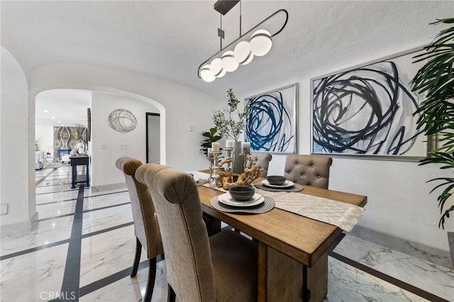 dining space featuring a textured ceiling