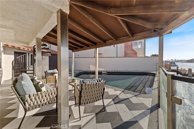 view of patio with an outdoor living space, a water view, and a swimming pool