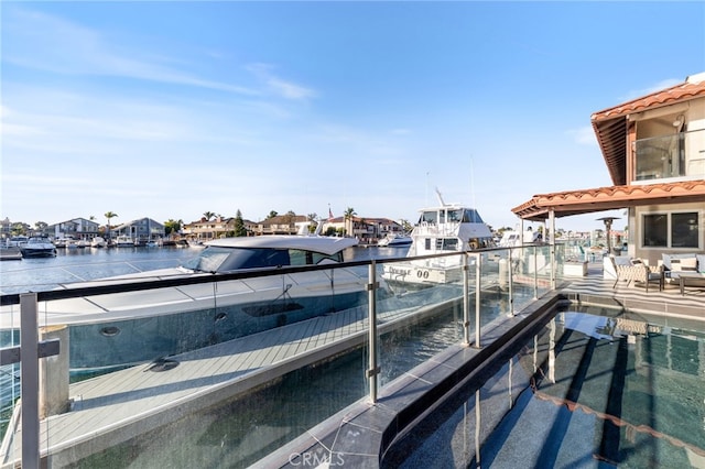 view of dock with a water view and a balcony