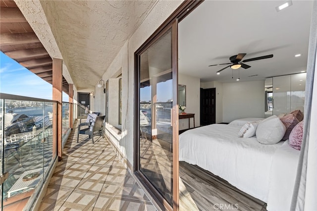 bedroom with multiple windows and ceiling fan