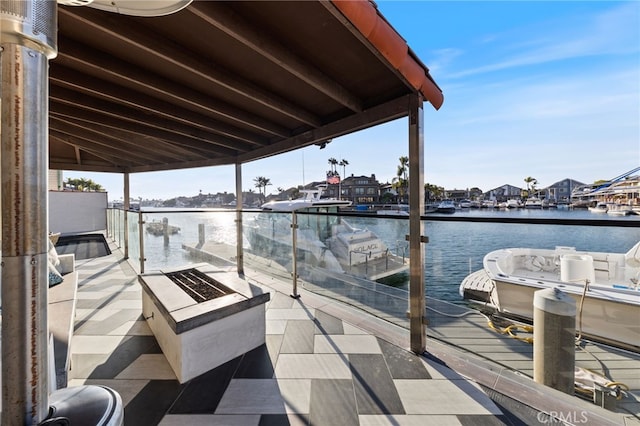 view of dock with a water view and a balcony