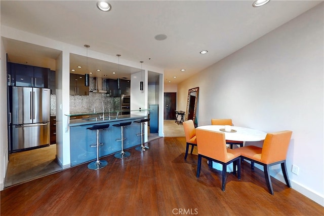 dining area with sink and dark wood-type flooring