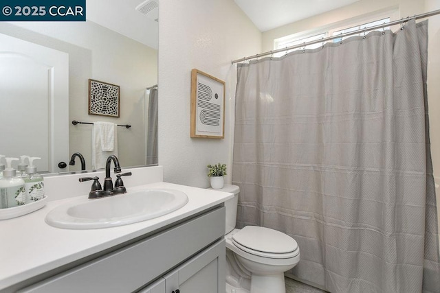 bathroom featuring vanity, a shower with curtain, and toilet