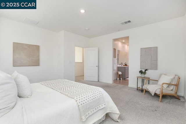 carpeted bedroom with ensuite bath