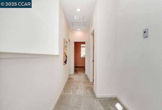 hallway featuring light colored carpet