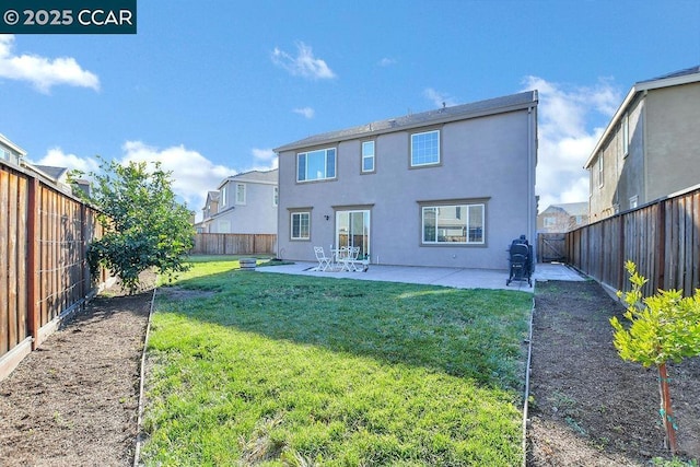 back of property with a lawn and a patio area