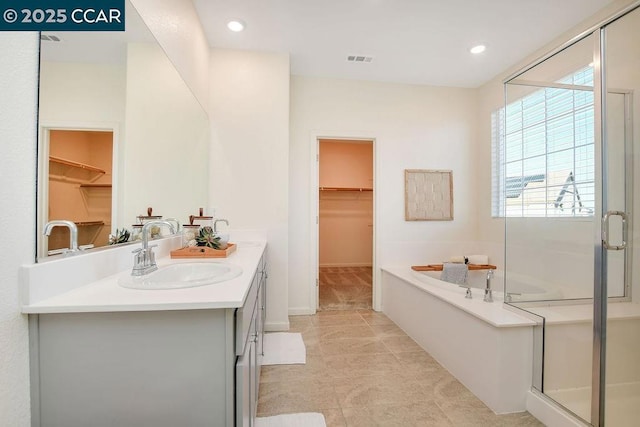 bathroom with plus walk in shower and vanity