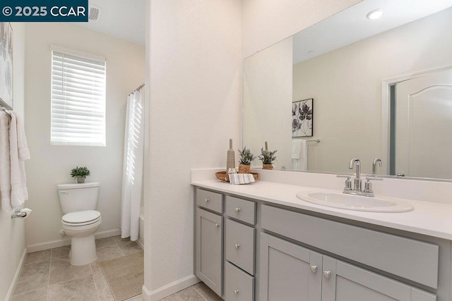 full bathroom with shower / bath combination with curtain, tile patterned floors, vanity, and toilet