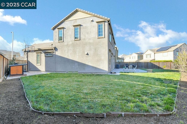 back of property with central AC unit, a lawn, and a patio