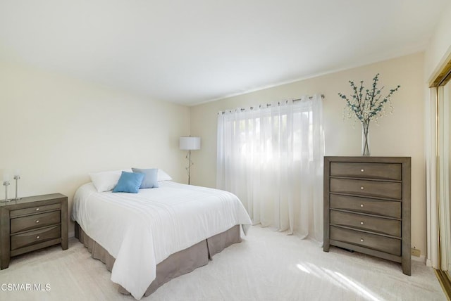 bedroom with light colored carpet