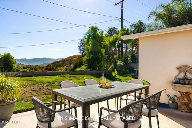 view of patio / terrace featuring a mountain view