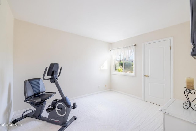 workout area featuring light carpet