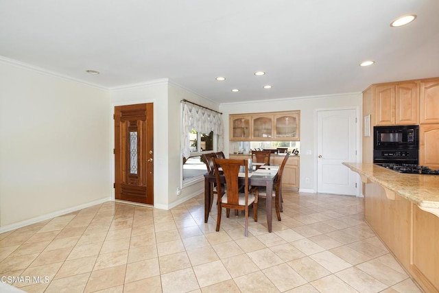 tiled dining room featuring ornamental molding