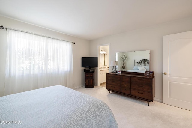 carpeted bedroom featuring connected bathroom