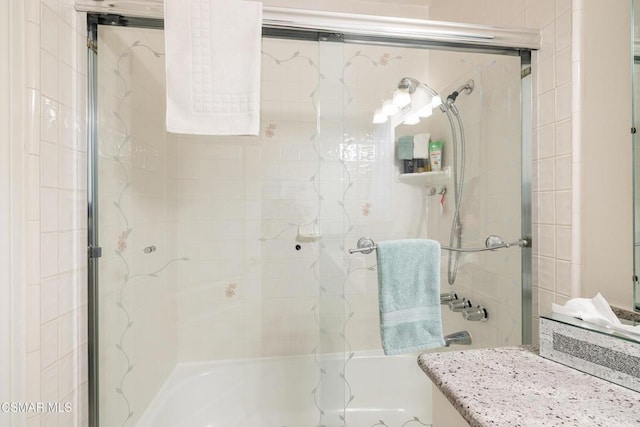 bathroom featuring shower / bath combination with glass door