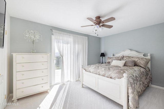 carpeted bedroom featuring multiple windows and ceiling fan