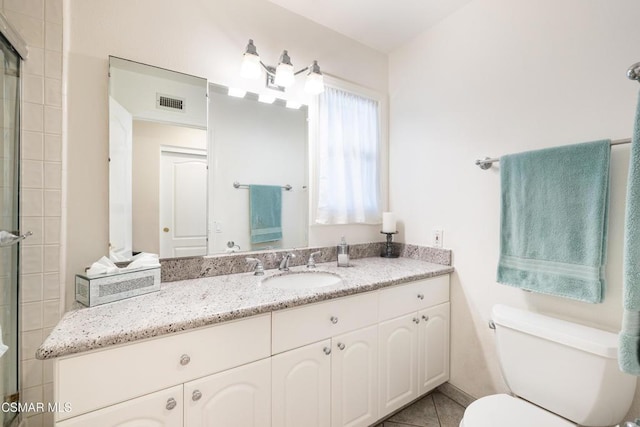 bathroom with vanity, tile patterned floors, and toilet