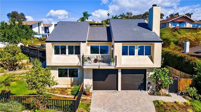 view of front of house with a balcony and a garage