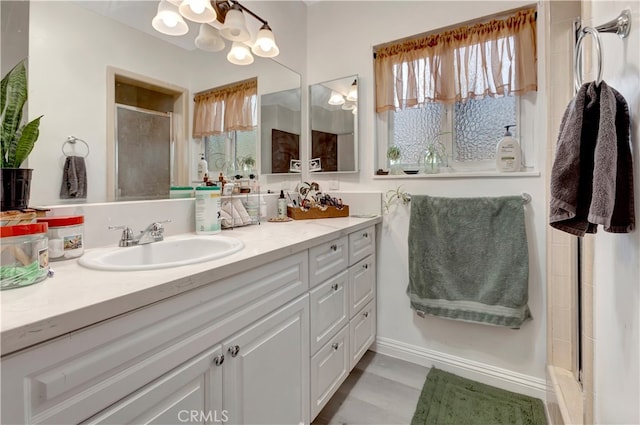 bathroom featuring vanity and a shower with shower door