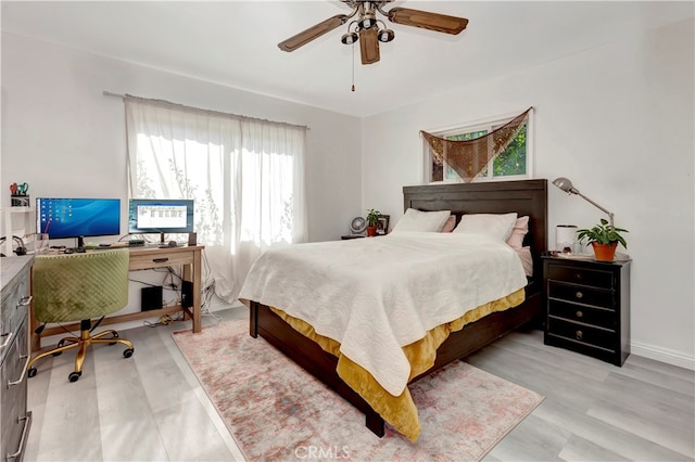 bedroom with light wood-type flooring and ceiling fan