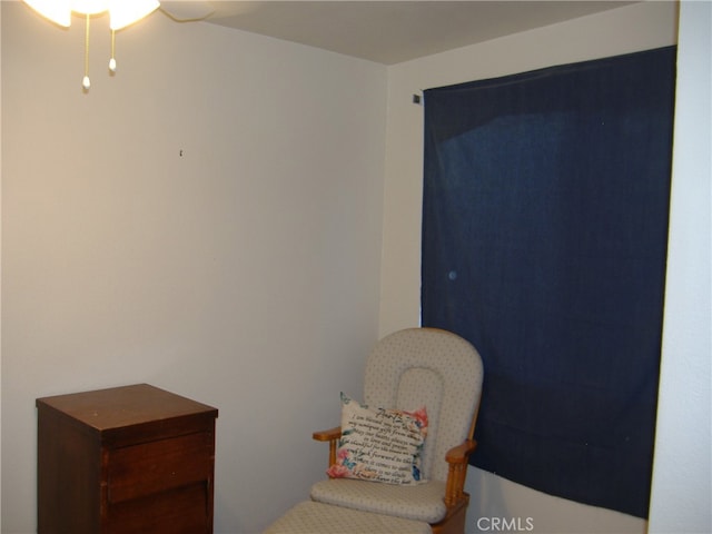 living area with ceiling fan