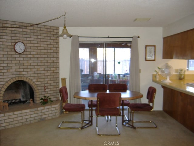 dining space with carpet and a fireplace