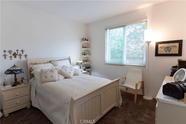 bedroom with dark colored carpet