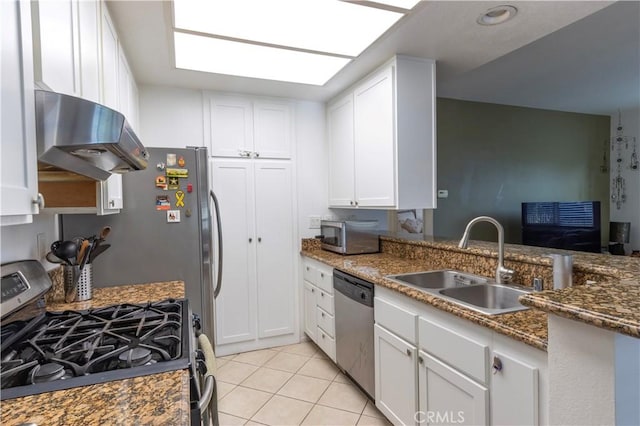 kitchen featuring white cabinetry, sink, dark stone counters, and appliances with stainless steel finishes