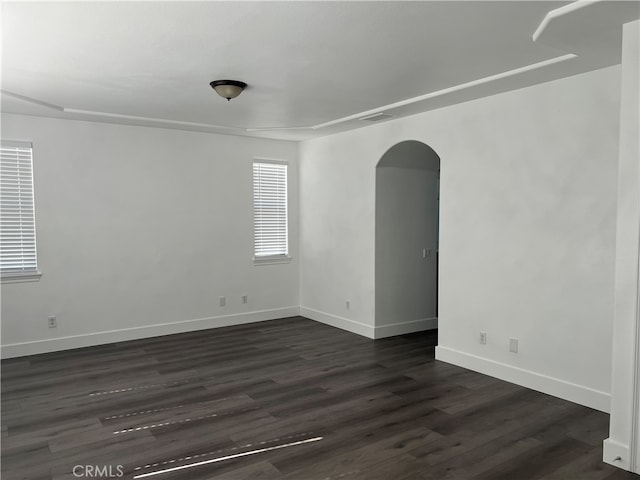 unfurnished room featuring dark hardwood / wood-style floors