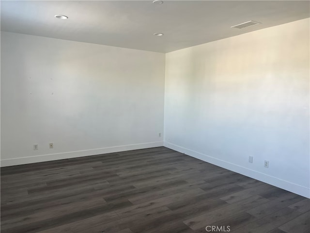 unfurnished room with dark hardwood / wood-style floors