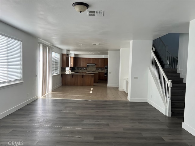 unfurnished living room with dark hardwood / wood-style flooring