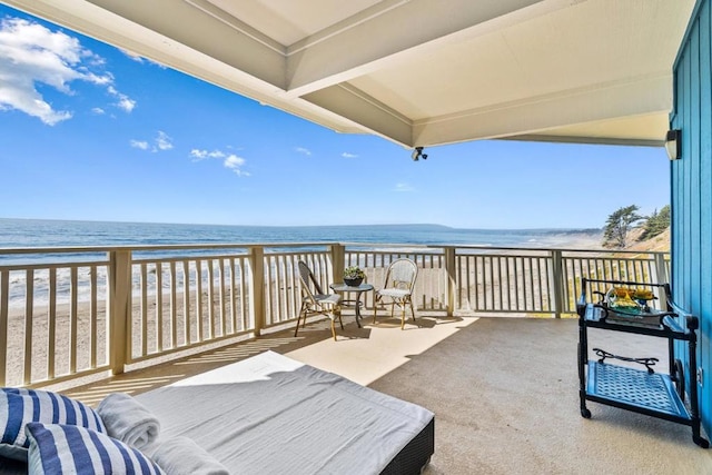 balcony featuring a water view and a view of the beach