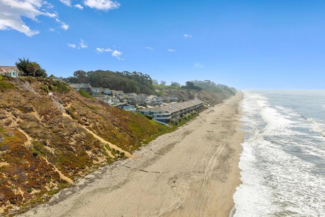 view of road with a view of the beach and a water view