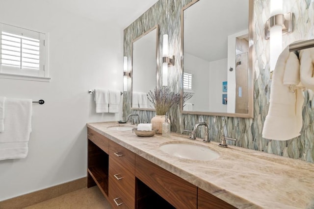 bathroom featuring vanity, tasteful backsplash, tile patterned floors, and a healthy amount of sunlight