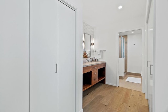 bathroom featuring vanity, wood-type flooring, and an enclosed shower