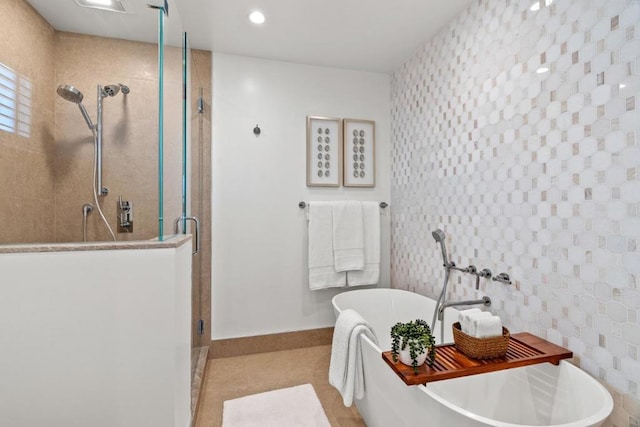 bathroom featuring tile patterned flooring, tile walls, and plus walk in shower