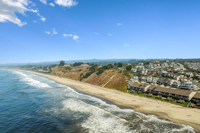 drone / aerial view with a water view and a view of the beach